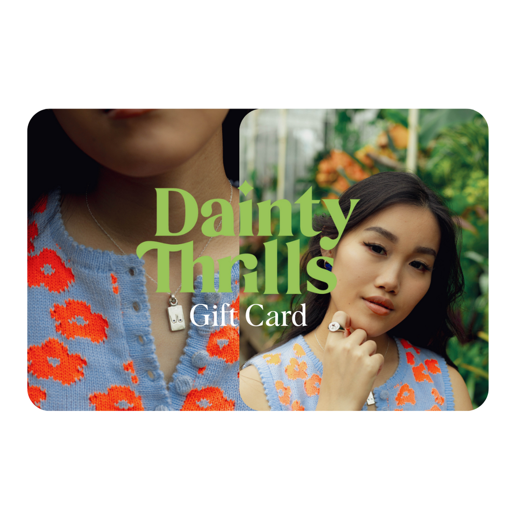 Dainty Thrills gift card with a woman wearing a dainty necklace and ring.